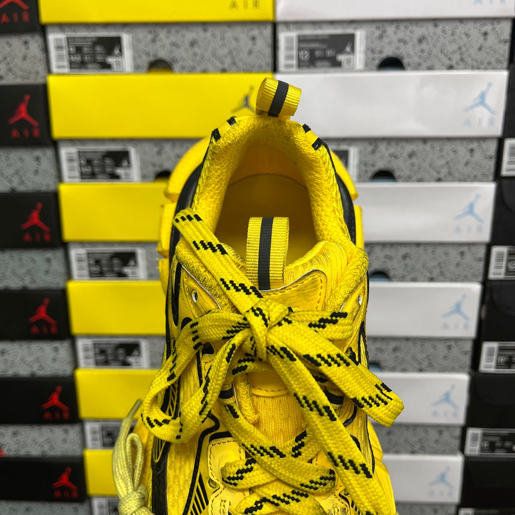 Yellow lace-up sneaker with black pull tab and padded knit collar