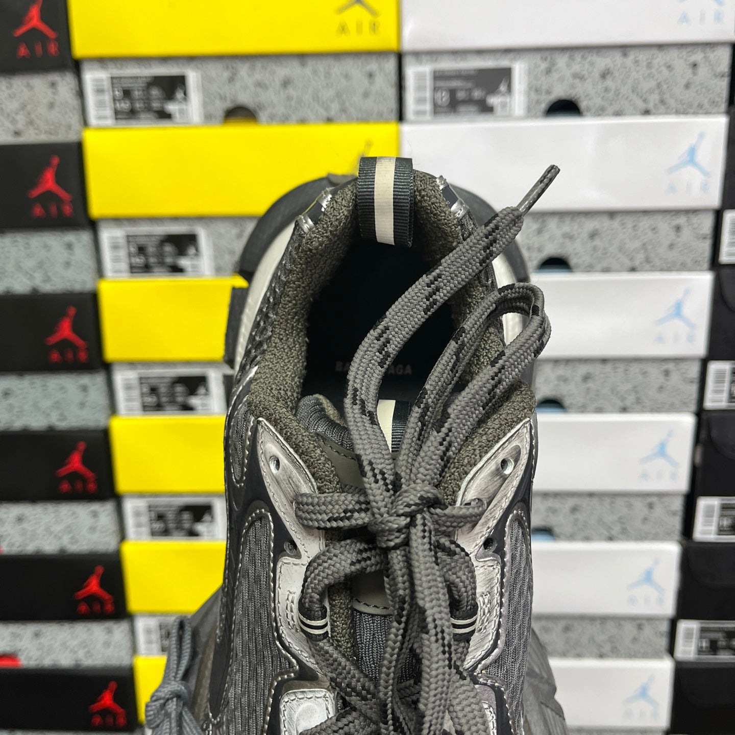 Balenciaga unisex sneaker interior view at heel, dark gray padded lining and lace-up laces
