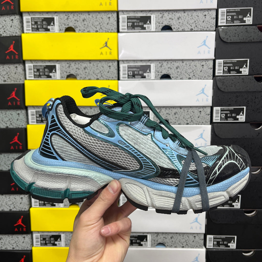 Unisex Balenciaga sneakers pair in light blue, gray and green with lace-up design