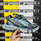 Unisex Balenciaga sneakers pair in light blue, gray and green with lace-up design