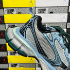 Unisex Balenciaga sneaker profile with light blue upper, green laces and dark heel