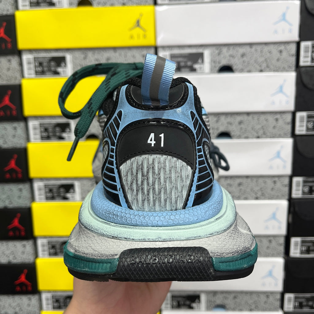 Unisex Balenciaga sneaker back view with blue-gray sole and green lace detail