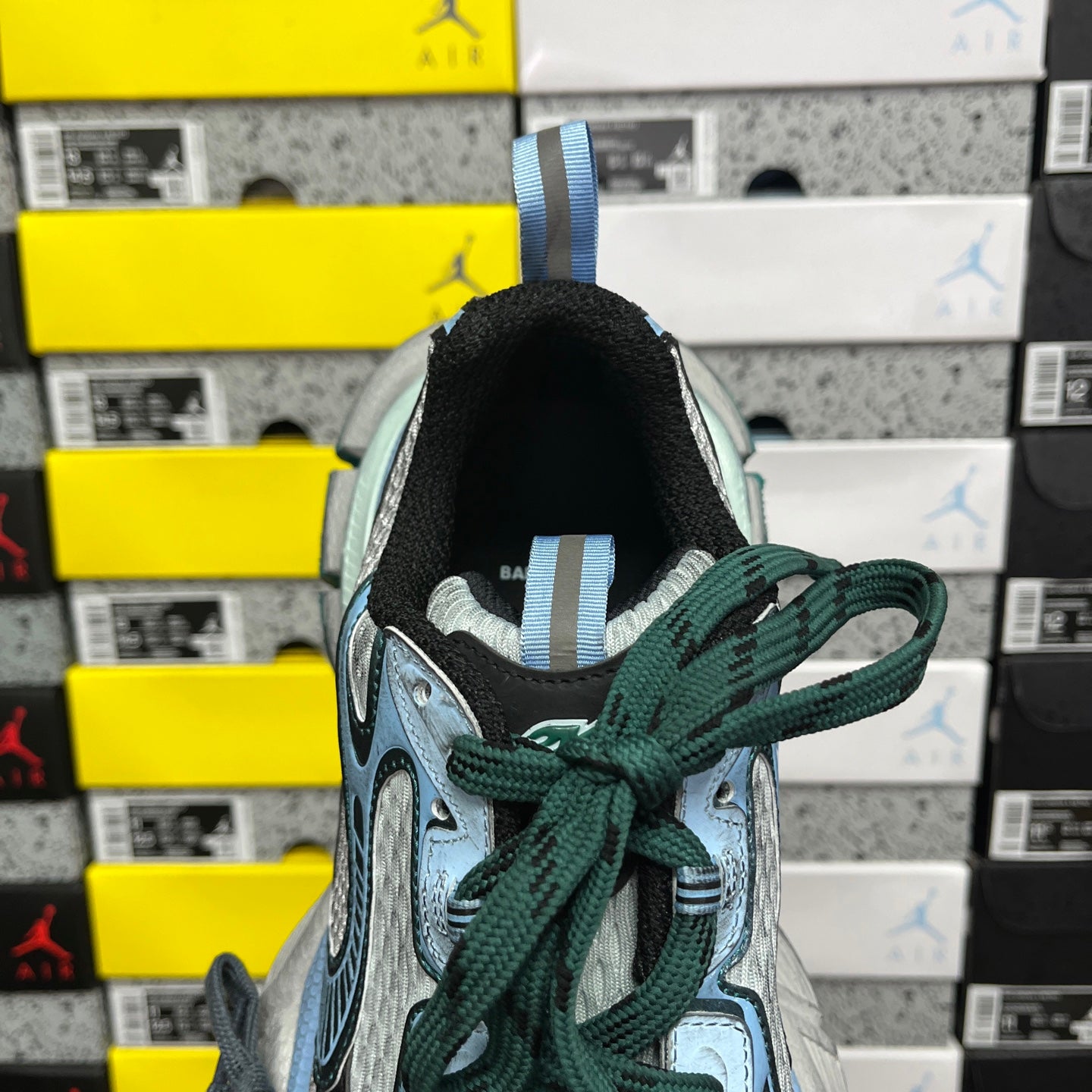 Unisex Balenciaga sneaker heel with green laces and blue strap loop
