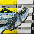 Unisex Balenciaga sneaker side view with blue sole, black stripe and green laces