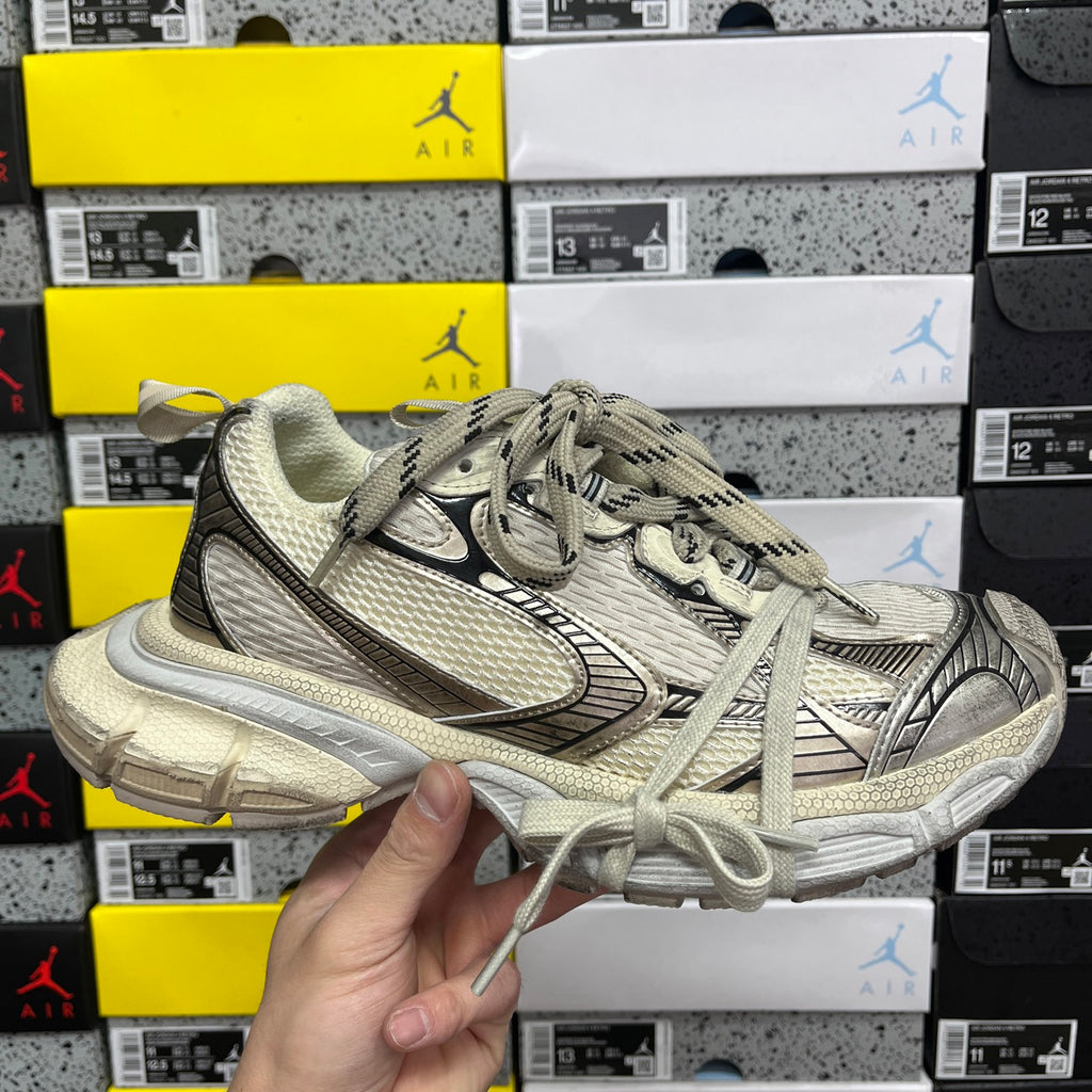 Balenciaga unisex sneaker, light gray mesh upper, black swoosh and lace-up design