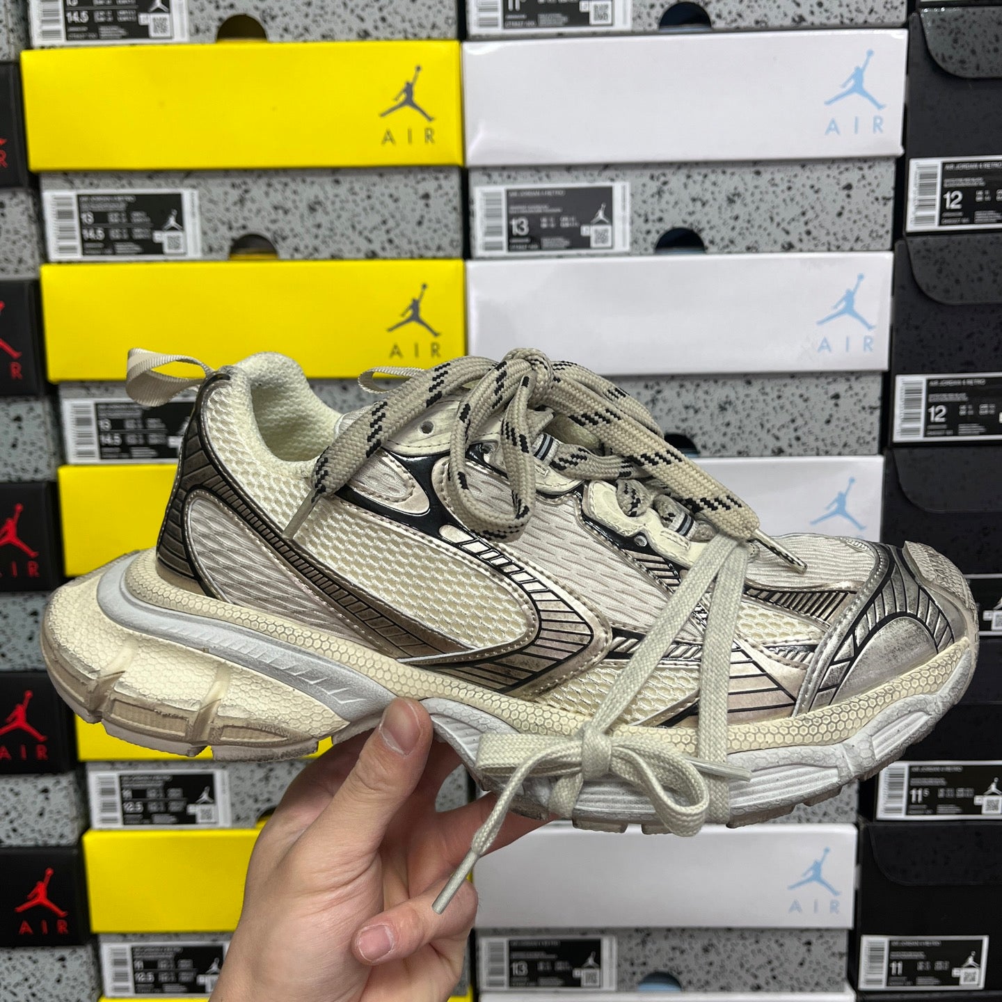 Balenciaga unisex sneaker, light gray mesh upper, black swoosh and lace-up design