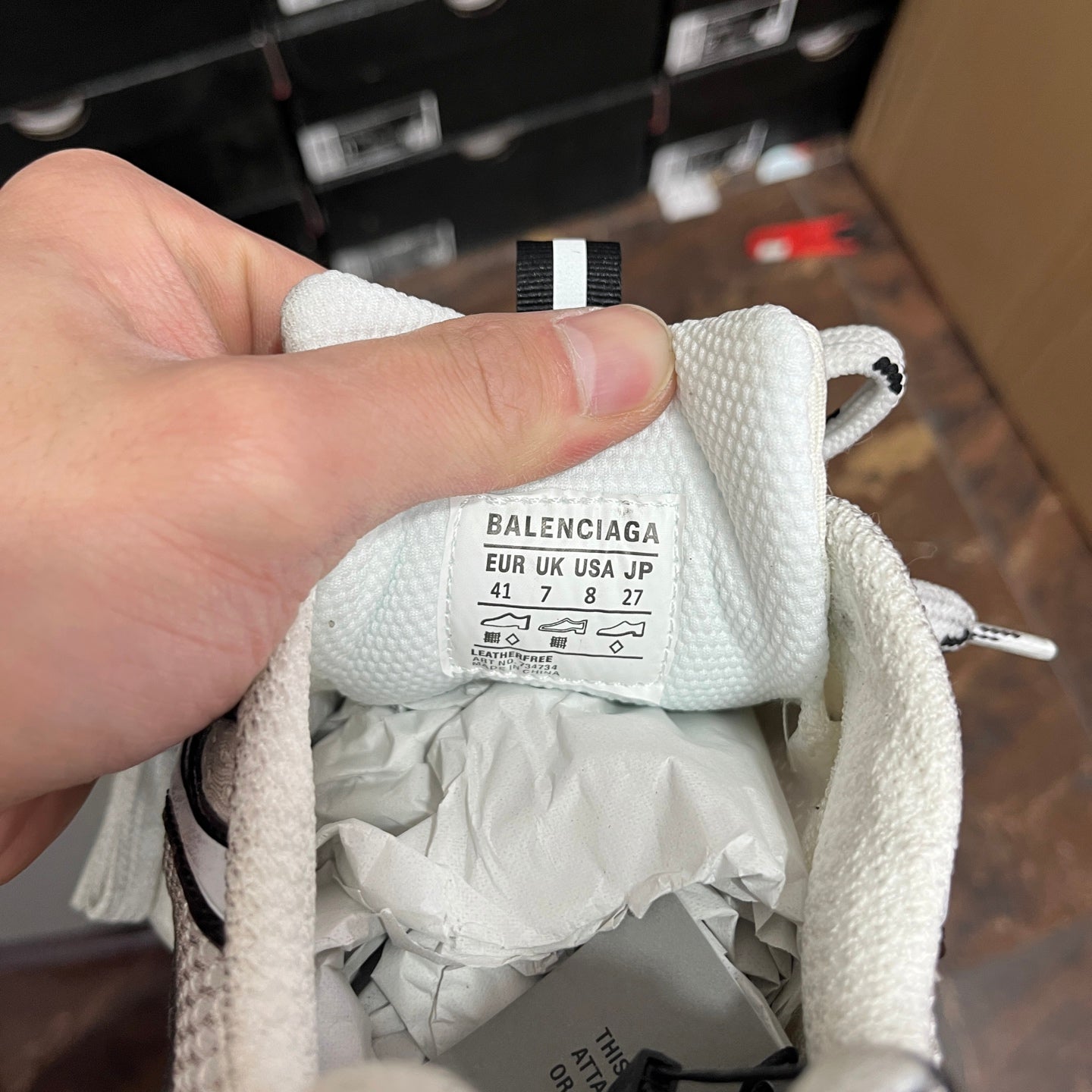 White Balenciaga sneaker inner label with size markings on the tongue.
