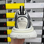 White Balenciaga sneakers heel view with black trim and gray sole band marked 41.