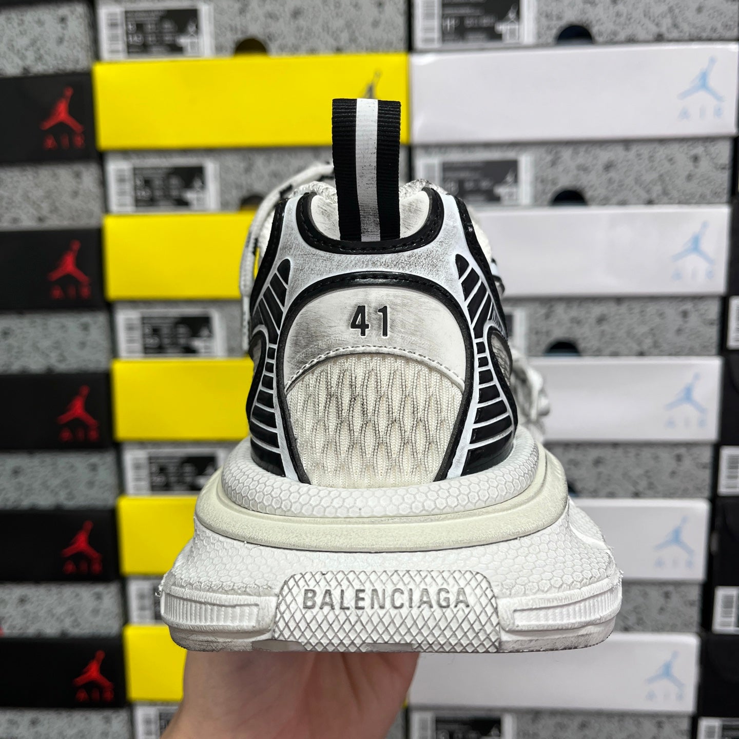 White Balenciaga sneakers heel view with black trim and gray sole band marked 41.