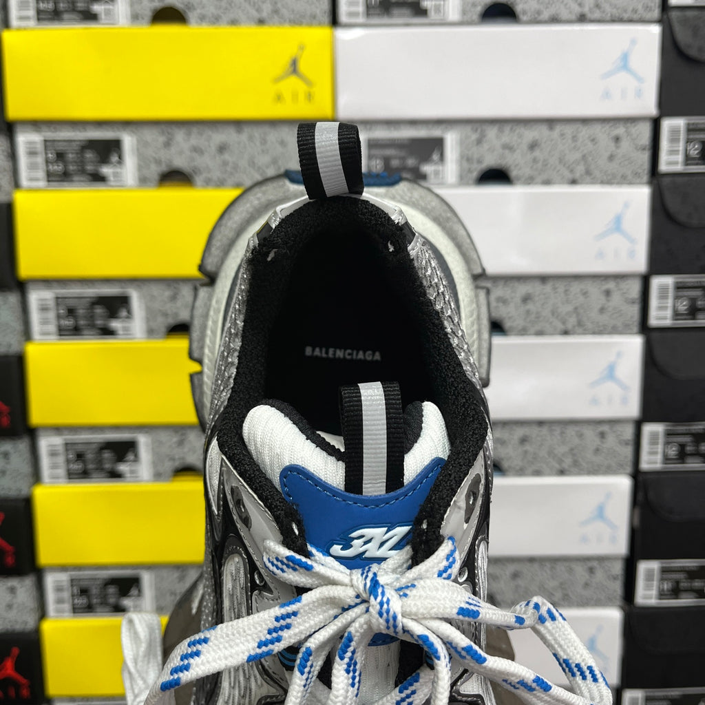 Balenciaga unisex sneakers rear view with black collar, white laces, and blue accents