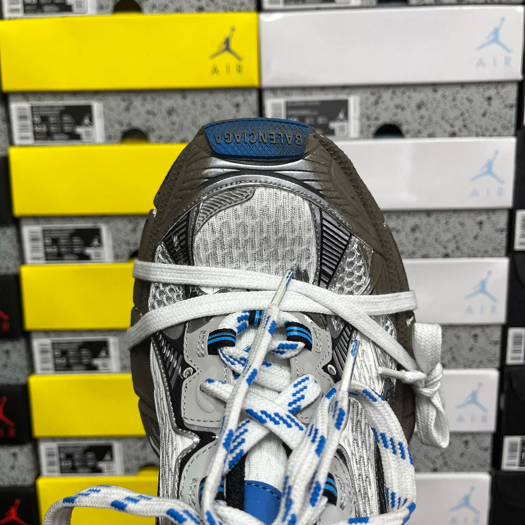 Balenciaga unisex sneakers close-up: silver tongue, patterned upper, and blue-striped laces