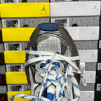 Balenciaga unisex sneakers close-up: silver tongue, patterned upper, and blue-striped laces