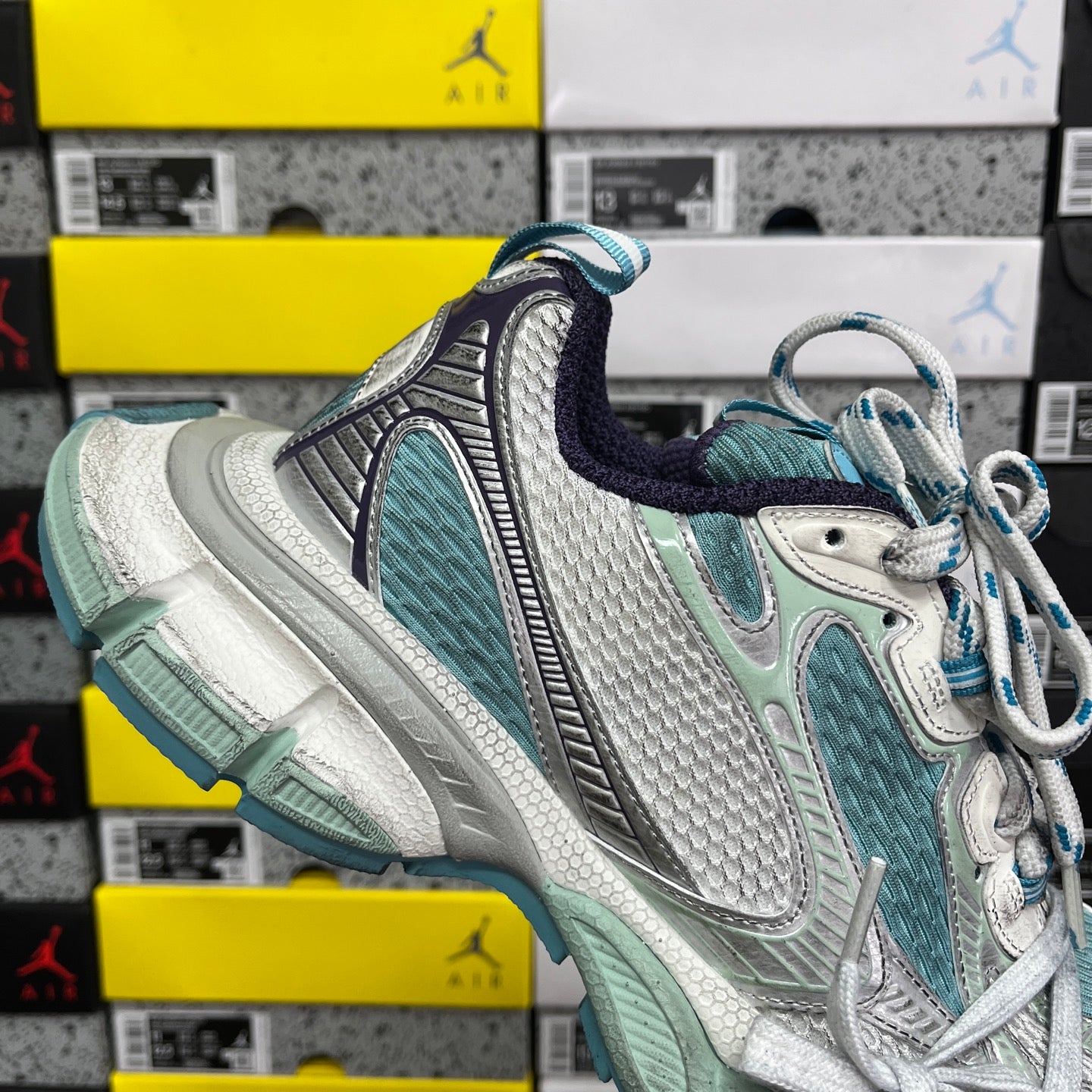 Balenciaga unisex sneaker side profile in teal, white, and silver with blue lace details