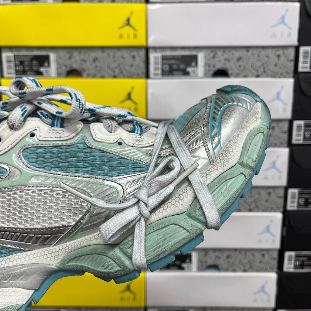 Balenciaga unisex sneaker close-up of laces and side panels in teal, white, and silver