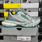 Balenciaga unisex sneaker side view in teal, white, and silver with blue-striped laces