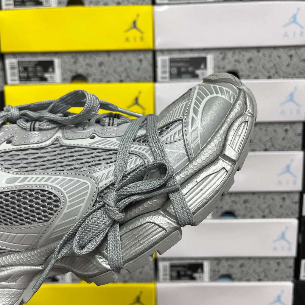 Gray mesh sneaker side view with laces and chunky molded rubber sole