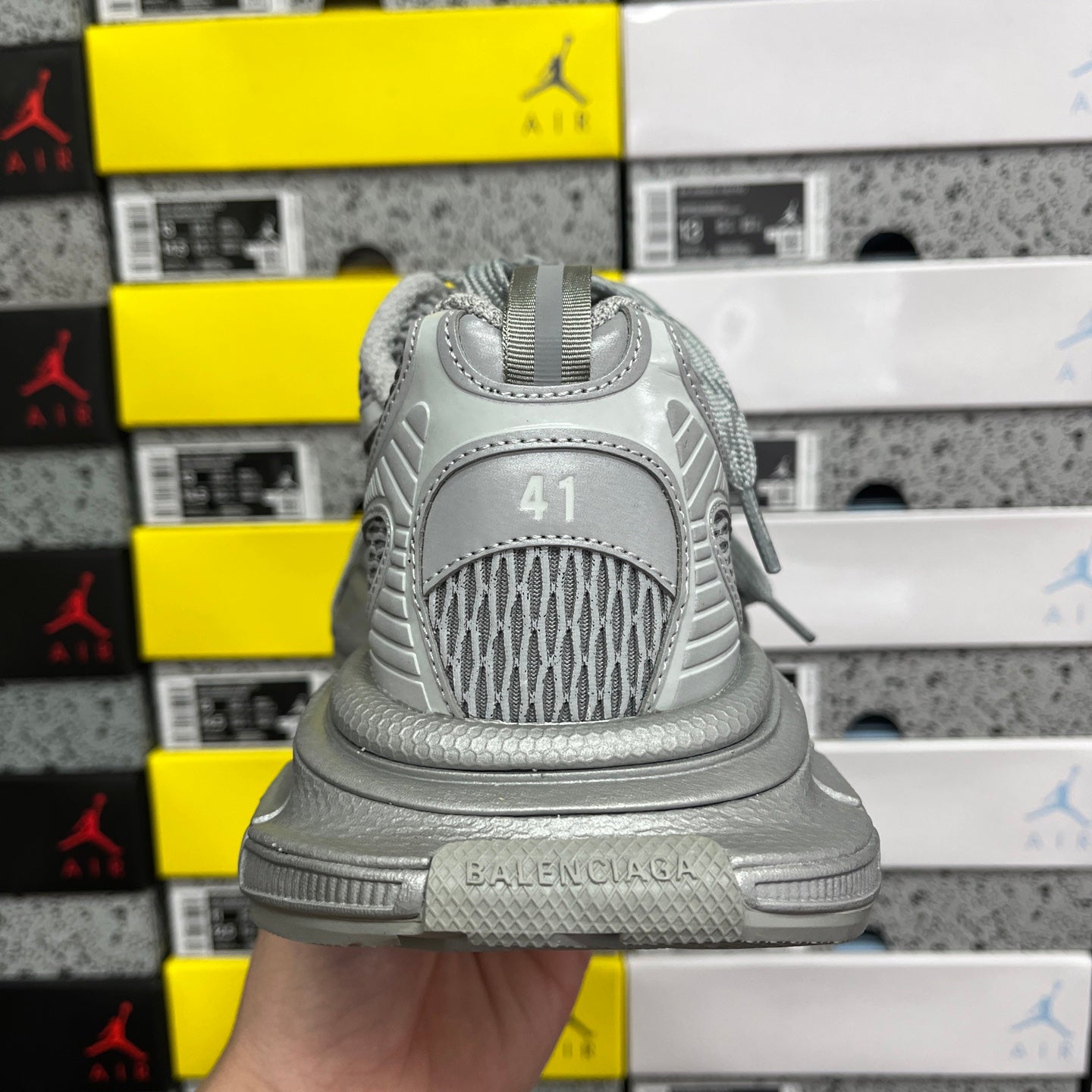 Gray sneaker heel with BALENCIAGA branding, cushioned back and lace tab