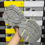 Silver-gray rubber outsole with deep grid tread and sturdy sidewall edge.