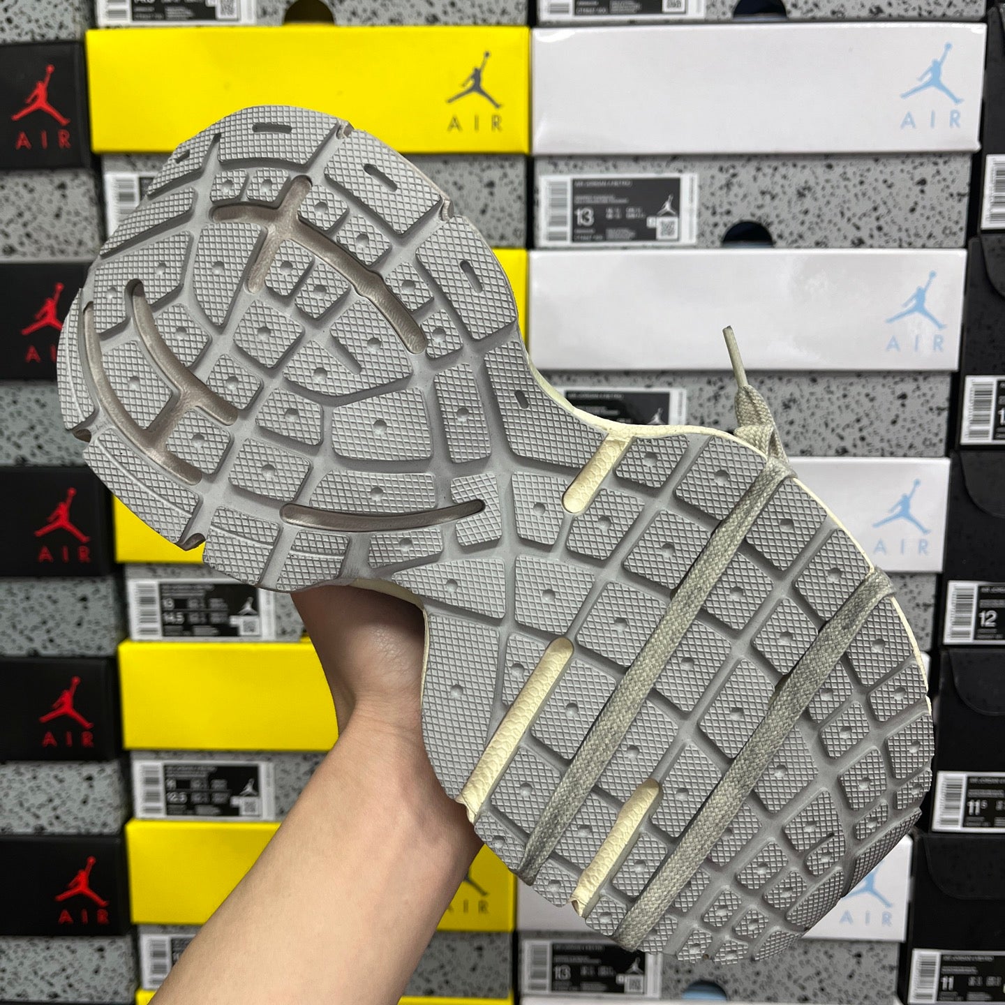 Silver-gray rubber outsole with deep grid tread and sturdy sidewall edge.