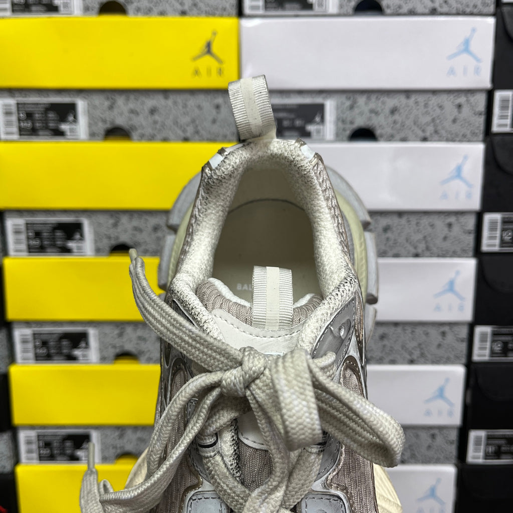 Silver-gray sneaker collar interior with woven laces and padded tongue lining.