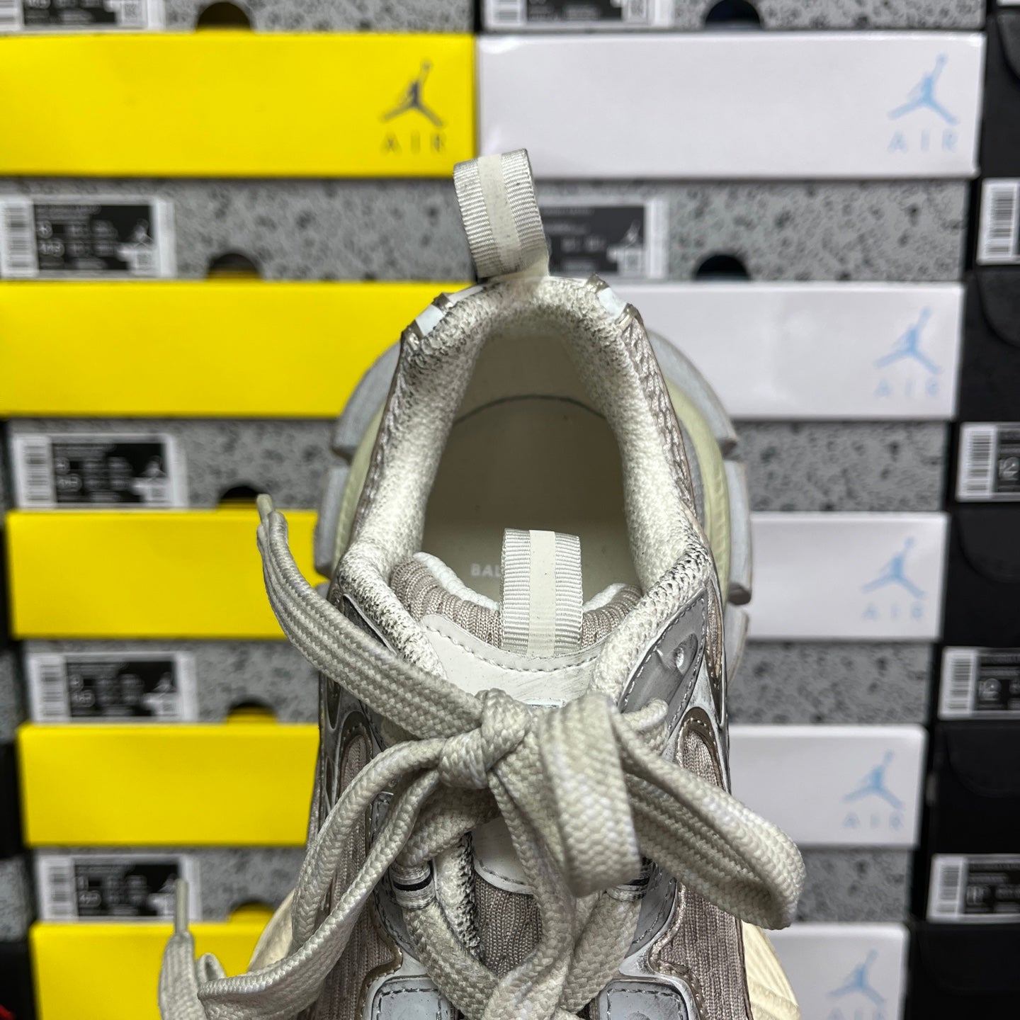 Silver-gray sneaker collar interior with woven laces and padded tongue lining.