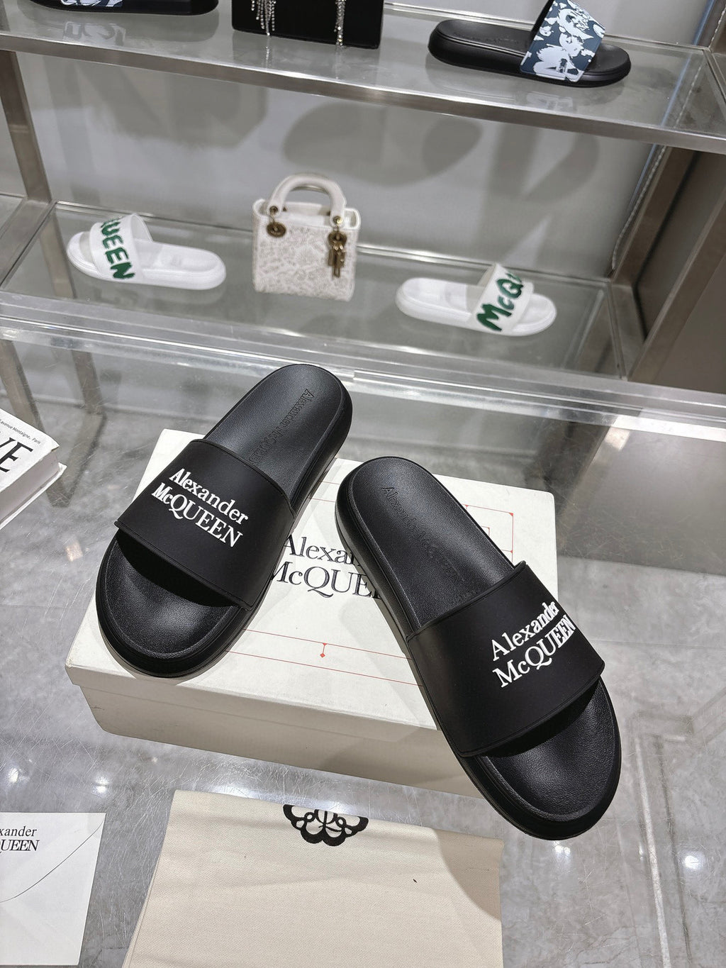 Pair of black Alexander McQUEEN slide sandals with wide logo strap
