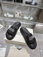 Pair of black Alexander McQUEEN slide sandals with wide logo strap