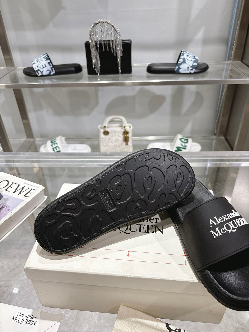Black Alexander McQUEEN slide sandal showing textured outsole tread