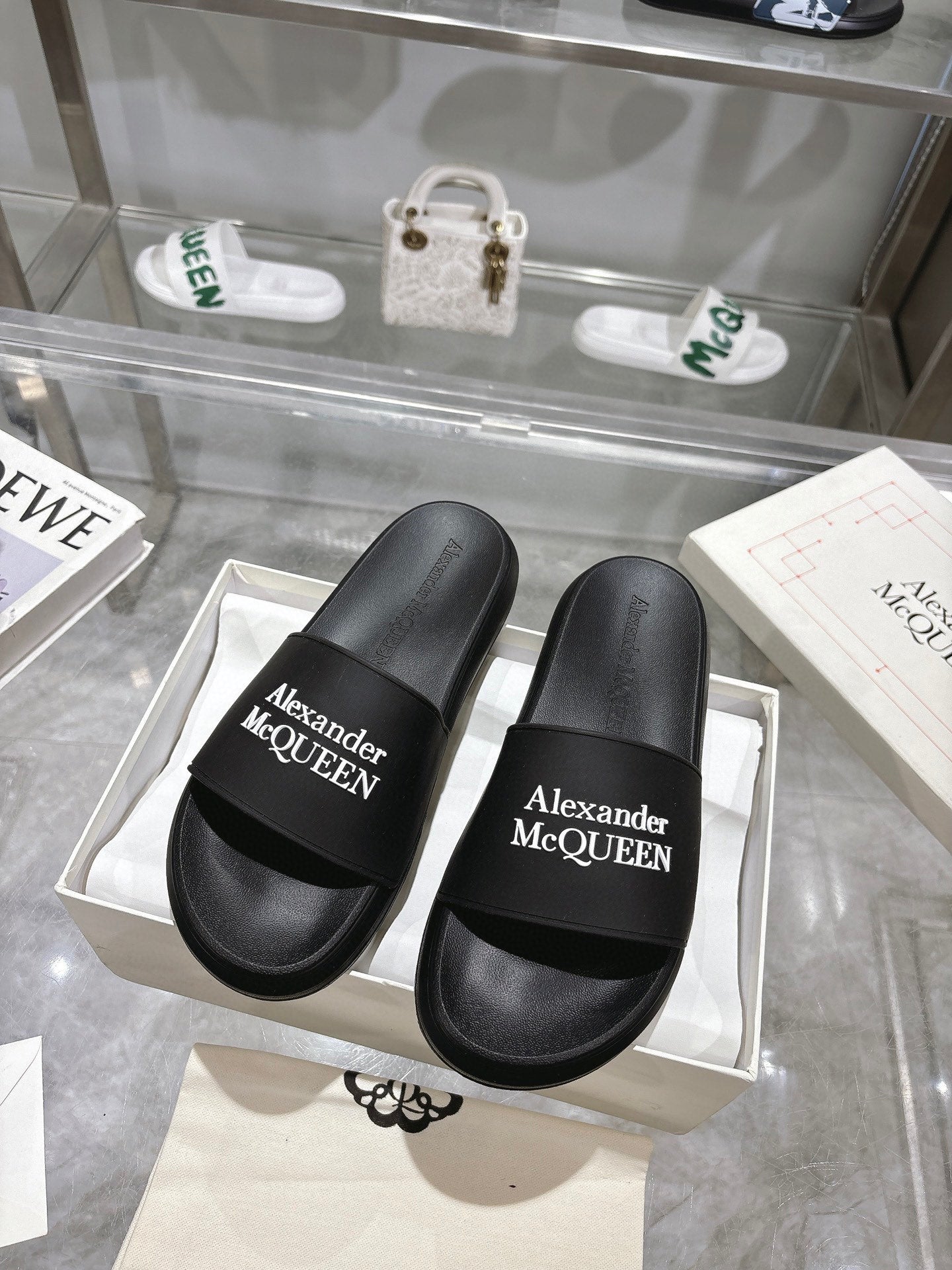 Black Alexander McQUEEN slide sandals with wide logo strap, pair view