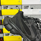 Black Balenciaga sneaker quarter view with lace-up, mesh upper, and padded collar