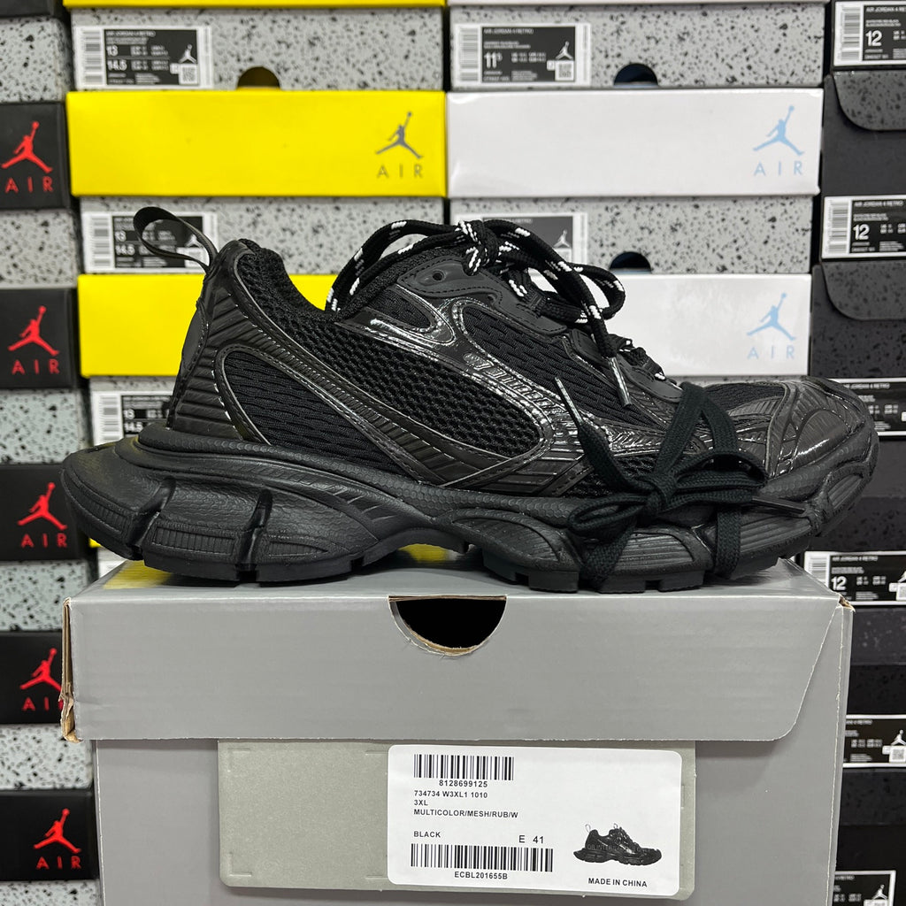 Black Balenciaga low-top sneakers on display with lace-up and chunky sole