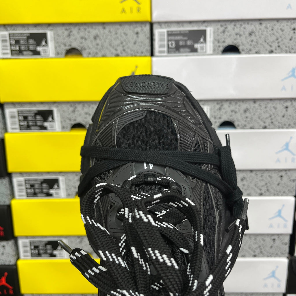 Black Balenciaga sneaker toe and laces with mesh and stitched overlays