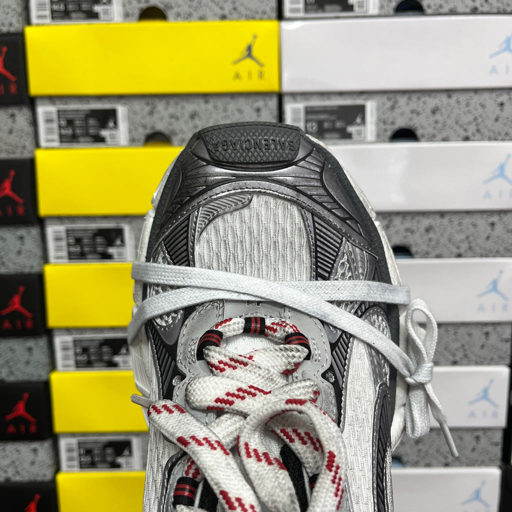Sneaker toe and lace-up front with grey mesh lining and red-and-black patterned laces