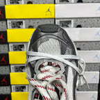 Sneaker toe and lace-up front with grey mesh lining and red-and-black patterned laces