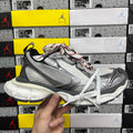 Chunky mesh sneaker with white laces, grey and black panels, red accent stitching