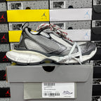 Mesh sneaker side view with white laces, grey upper, black trim, red stitched details