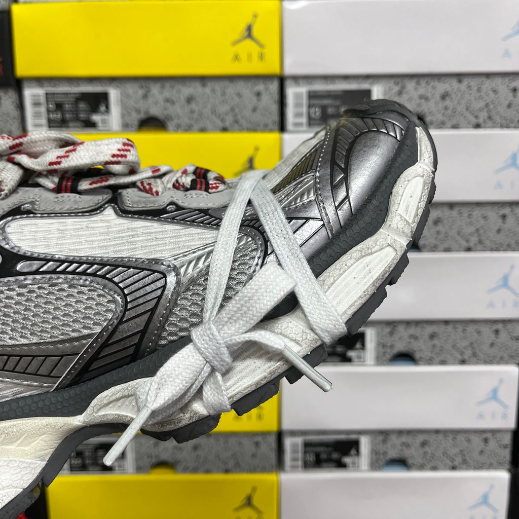 Sneaker heel and side panel close-up with textured grey upper and white lace ties
