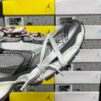 Sneaker heel and side panel close-up with textured grey upper and white lace ties