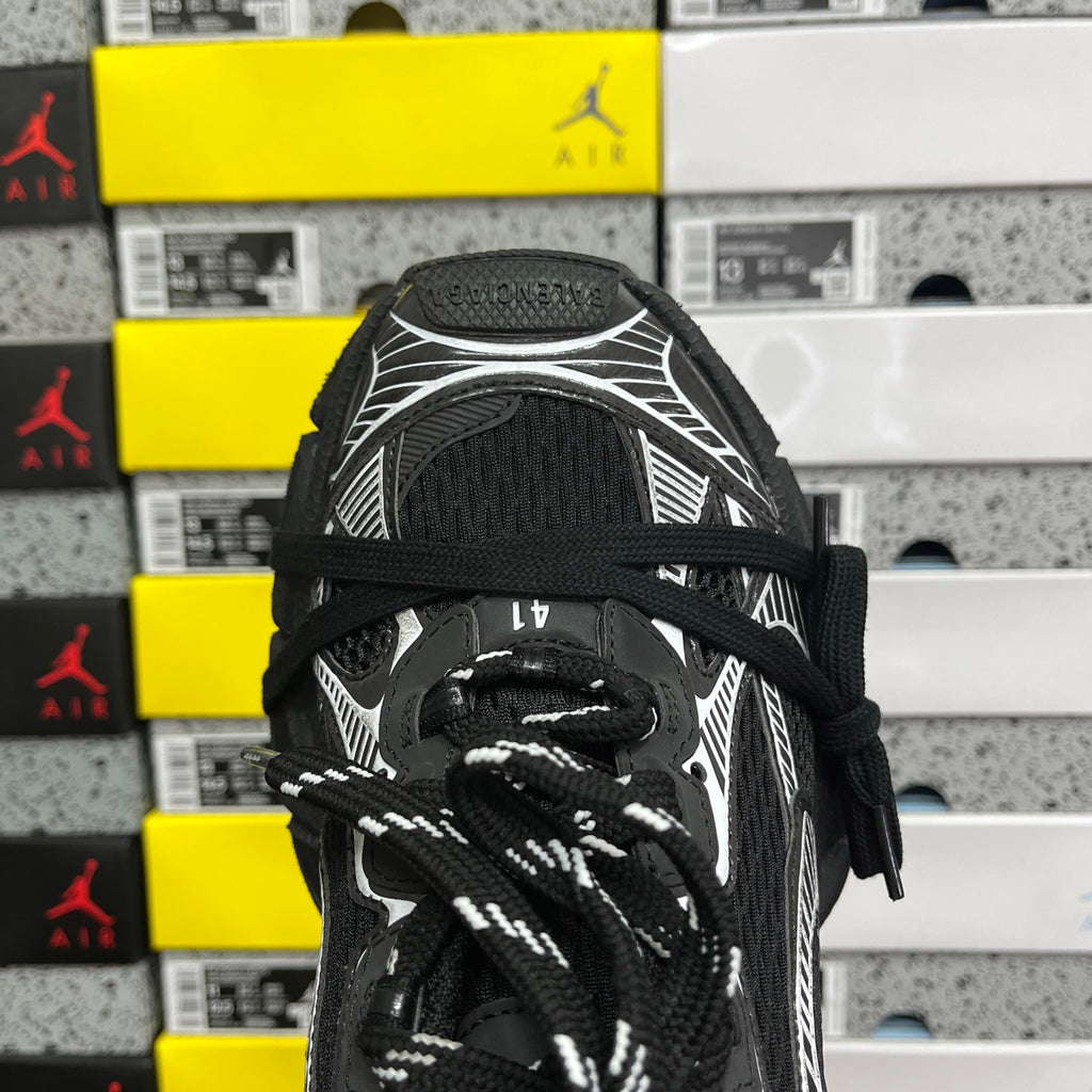 Black sneaker tongue and laces with white ribbed overlay and textured collar