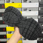 Black sneaker outsole with grid traction pattern and raised rubber tread blocks