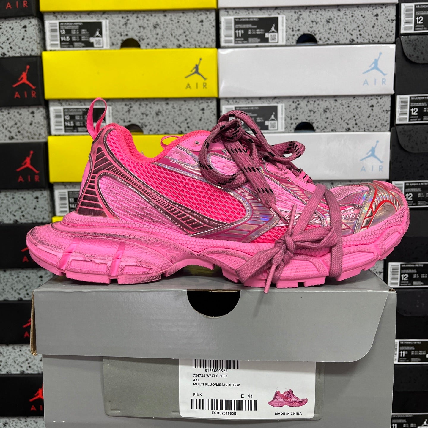 Pink lace-up sneakers on shoe box, molded side panel and chunky sole