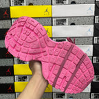 Pink sneaker outsole with raised traction pattern