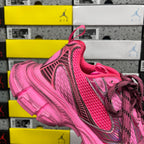 Pink lace-up sneakers with curved side stripes and thick molded sole