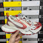 Balenciaga unisex sneaker with white mesh uppers and red side panel details