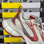 Balenciaga unisex sneaker 3/4 view with red side stripes and white textured sole