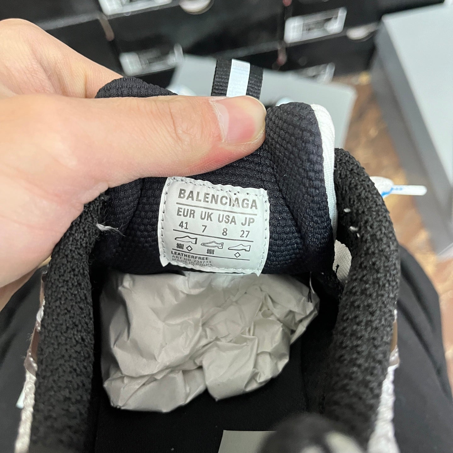 Inside label of black sneaker showing size info and brand name BALENCIAGA