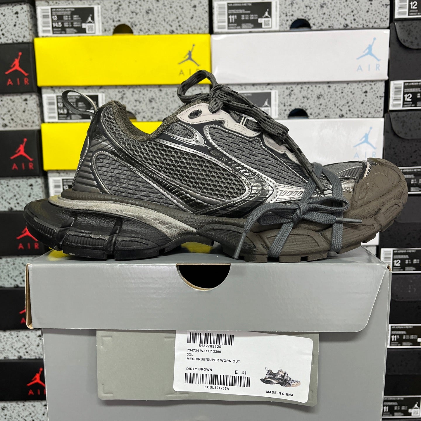 Unisex running sneaker side view with gray mesh upper, black accents, lace-up