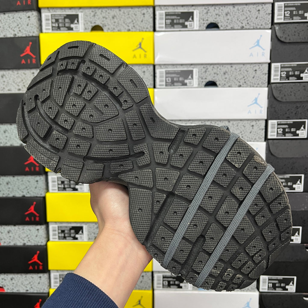 Unisex running sneaker outsole tread in dark gray with traction pattern