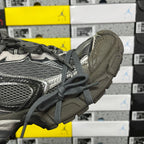 Unisex running sneaker heel side view with gray upper and ribbed outsole