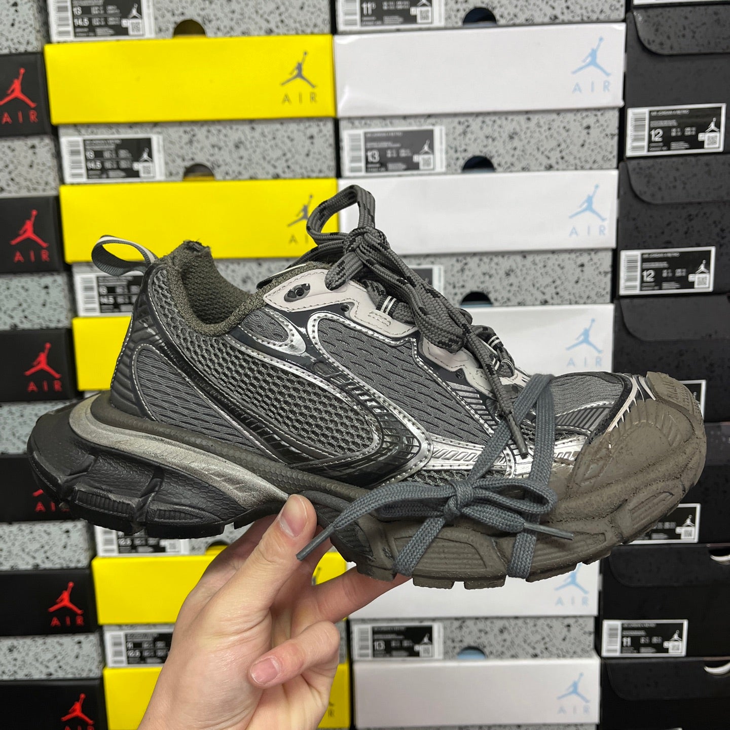 Unisex running sneaker in gray with black mesh panels and lace-up closure